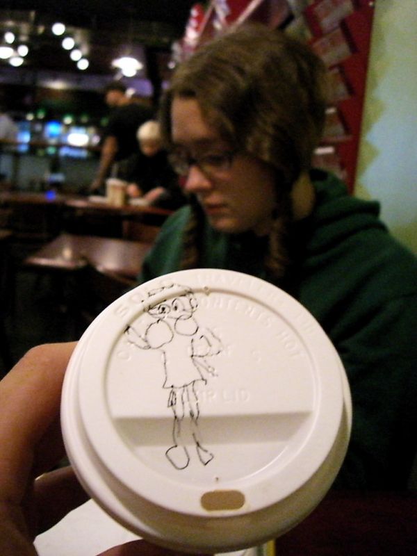 Betty Boop on a coffee cup lid (and her creator in the background)
